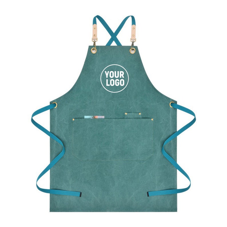 May include: Teal canvas apron with adjustable straps, a large pocket, and a white circle with the text "YOUR LOGO" in the center.
