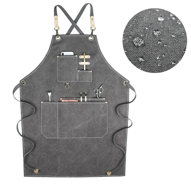 May include: A gray canvas apron with multiple pockets and a leather strap. The apron has a water-resistant finish.