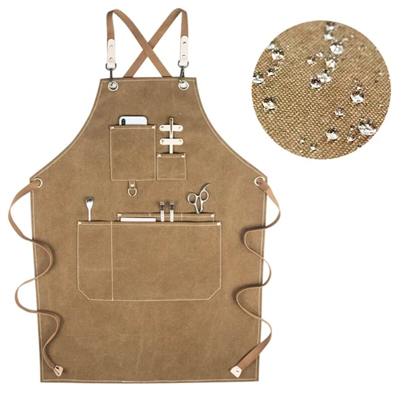 May include: A brown canvas apron with multiple pockets and a leather strap. The apron has a cross-back design and is water-resistant.