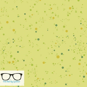 May include: A yellow fabric with a scattered pattern of green and gold circles.