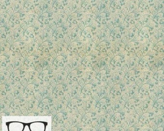 May include: A beige fabric with a repeating pattern of small blue flowers and leaves. The fabric has a slightly textured surface.