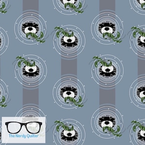 May include: A seamless pattern featuring a black and white cartoon animal face with green foliage inside a circle of white lines on a light blue background with vertical gray stripes. The text "The Nerdy Quilter" is at the bottom of the image.