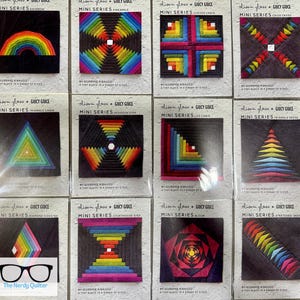 May include: A collection of twelve mini-series quilt block patterns, each featuring geometric designs in vibrant colors. The patterns include a rainbow, pineapple, curved cabin, crisscross, triangle cabin, hexagon step, log cabin, triangle geese, diamond sidestep, courthouse step, bloom, and stretched geese.