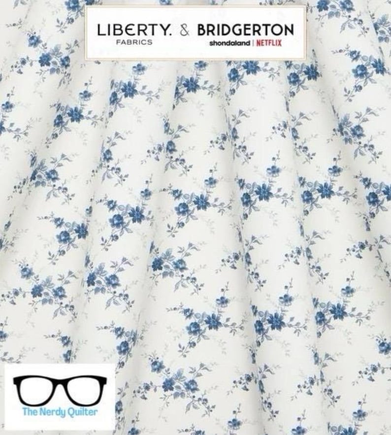 May include: White fabric with a blue floral pattern. The fabric has a small, delicate floral design with blue flowers and leaves. The fabric is perfect for quilting, sewing, and crafting.