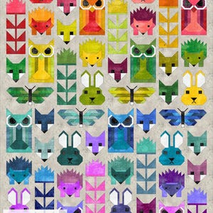 May include: A colorful quilt pattern featuring various animal and nature motifs, including owls, foxes, butterflies, rabbits, and flowers. The quilt is made with a variety of fabrics in shades of red, orange, yellow, green, blue, purple, and pink. The quilt is displayed on a gray background. The text "The Nerdy Quilter" is visible in the bottom left corner.