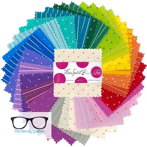May include: A colorful fabric bundle arranged in a circular pattern, showcasing a spectrum of hues from blue to red. The fabrics feature various patterns, including stripes and polka dots. A label with the text "Free Spirit" and "Tula Pink" is visible.