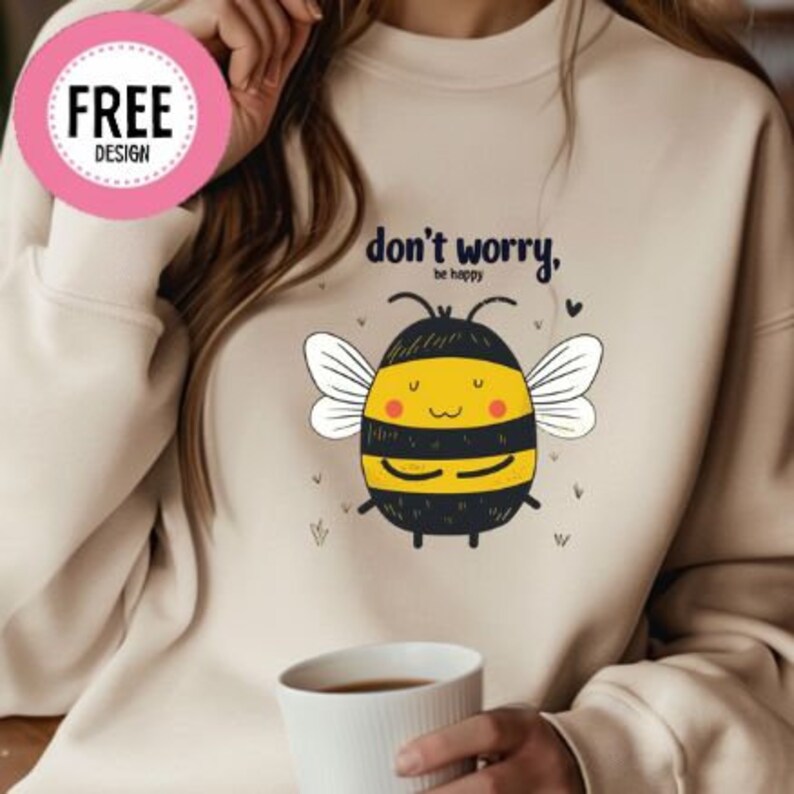 May include: A beige sweatshirt with a cartoon bee graphic and the text "don't worry, be happy".