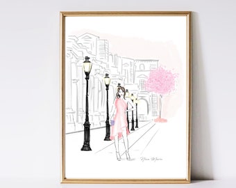 May include: A watercolor illustration of a woman in a pink dress walking down a street lined with lampposts. The buildings in the background are drawn in black and white, while the woman and the cherry blossom tree are in color. The illustration is signed "Nina Maria".