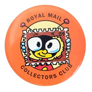 May include: A round orange pinback button featuring a cartoon character with large eyes and antennae emerging from a brown postage stamp frame. The text ROYAL MAIL COLLECTORS CLUB is printed in black around the circular edge of the button.