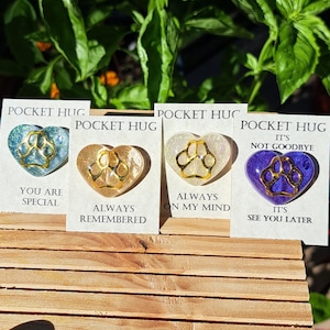 May include: Four heart-shaped resin keepsakes with gold paw prints and glitter. Each keepsake has a different message: "You are special", "Always remembered", "Always on my mind", and "It's not goodbye, see you later".