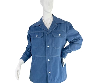 May include: A blue denim jacket with a button-up front, two flap pockets, and a pointed collar.