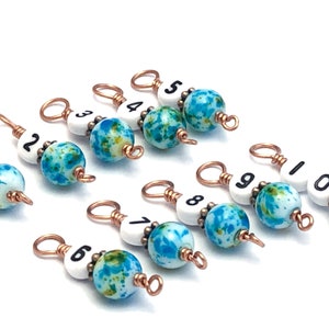 May include: Ten turquoise and white speckled beads with copper wire loops and black numbers 1 through 10.