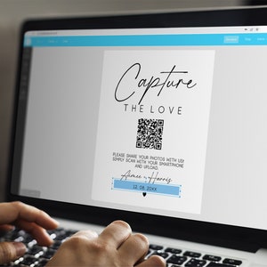 May include: A laptop screen displaying a wedding photo booth sign with a QR code. The sign reads "Capture the Love" and includes the names "Aimee & Harris" and the date "12. 08. 20XX".