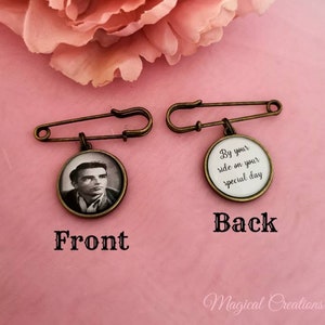 May include: A bronze safety pin with a round charm. The front of the charm has a black and white photo of a man. The back of the charm has the text "By your side on your special day".