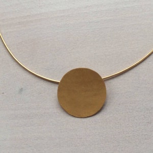 Golden pendant forged round