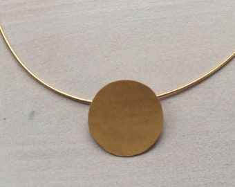 Golden pendant forged round