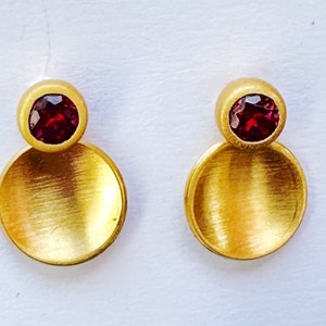 Golden earrings with garnet studs
