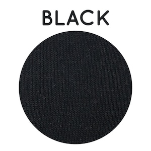 May include: A close-up of black fabric with a textured, ribbed surface.