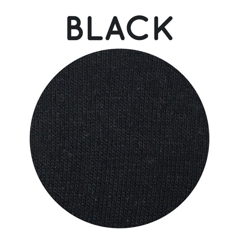 May include: A close-up of black fabric with a textured, ribbed surface.