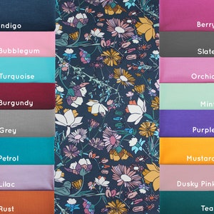 May include: A swatch card with 12 fabric samples in various colors, including indigo, bubblegum, turquoise, burgundy, grey, petrol, lilac, rust, berry, slate, orchid, mint, purple, mustard, dusky pink, and teal. The fabric samples are arranged in two columns, with the colors on the left side of the card and the names of the colors on the right side of the card.
