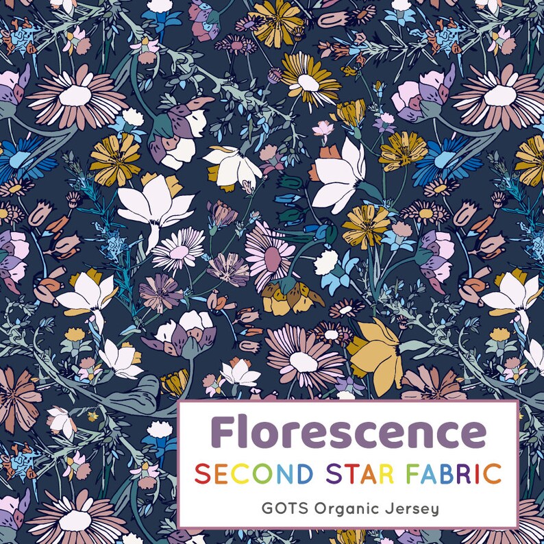May include: A navy blue fabric with a floral pattern featuring white, pink, yellow, and blue flowers. The fabric is labeled "Florescence Second Star Fabric GOTS Organic Jersey".