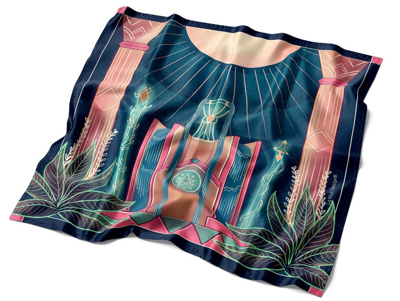 May include: A blue and pink patterned silk scarf with a geometric design featuring a central image of a throne with a star and a sun above. The scarf has a green and pink border with a floral design.