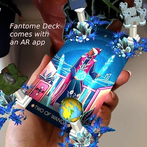 May include: A tarot card with a blue background and a person in a red and gold robe holding a blue orb. The card is titled "Two of Wands" and has a blue and white design. The card is surrounded by blue and white crystals and a white structure.