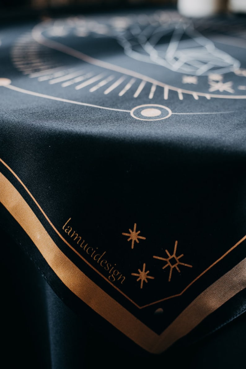 May include: Black velvet cloth with a gold geometric design and the text "lamuci design" in gold lettering.