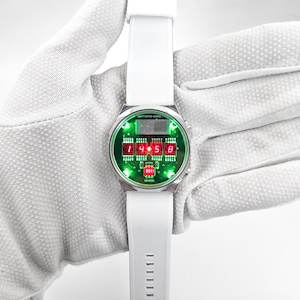 May include: A silver wristwatch with a white band and a green and red digital display. The display shows the time as 1:45:58. The watch has the text "24/7 TEMPO - 32847" and "MEXICO" printed on the face.