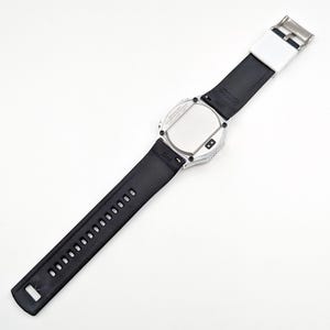 May include: A silver-toned wristwatch with a black rubber band. The watch face is round and has a black background. The watch has a silver-toned bezel with a black rubber band.