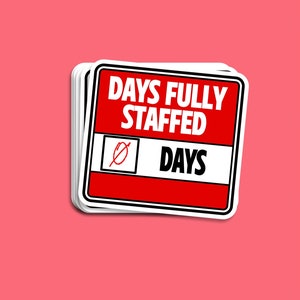 May include: A red and white sticker with the text "DAYS FULLY STAFFED" and a crossed-out box with the word "DAYS" inside. The sticker has a white border and is slightly curled at the edges.