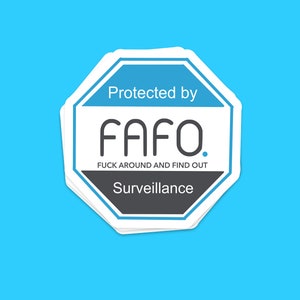 May include: A stack of white octagonal stickers with a blue border and text. The top sticker reads "Protected by FAFO. FUCK AROUND AND FIND OUT. Surveillance" in white and black text on a blue and gray background. The background is light blue.