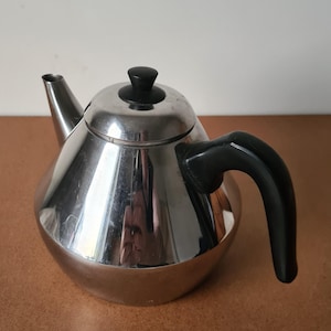 May include: A handmade wooden sign with the text "Welcome" in a playful font. The sign is painted white with a distressed finish, and features a decorative floral design in shades of pink and green. Includes a jute rope for hanging.