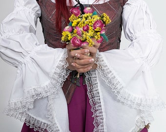 white blouse in renaissance or medieval style with bell shaped sleeves