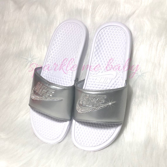 white and silver nike slides
