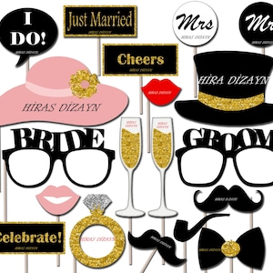 May include: A collection of wedding photo booth props on sticks, including a pink hat, black top hat, glasses with Bride and Groom text, champagne flutes, a gold ring, mustaches, a bow tie, lips, and signs with text like Just Married and Cheers.