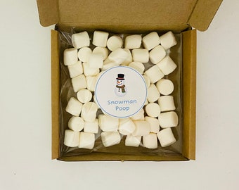 May include: A brown cardboard box containing white marshmallows in a clear bag. A circular label with a snowman illustration and the text "Snowman Poop" is visible amongst the marshmallows.