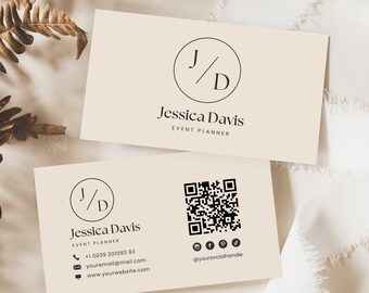 May include: Two cream-colored business cards with black text. The top card has the initials "J/D" in a circle and the text "Jessica Davis, Event Planner". The bottom card has the same initials, contact information, and a QR code.