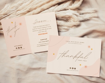 May include: A pink and white thank you card with gold lettering. The card has a handwritten message that says "thank you" and "thankful for you". The card also includes social media icons and a website address.