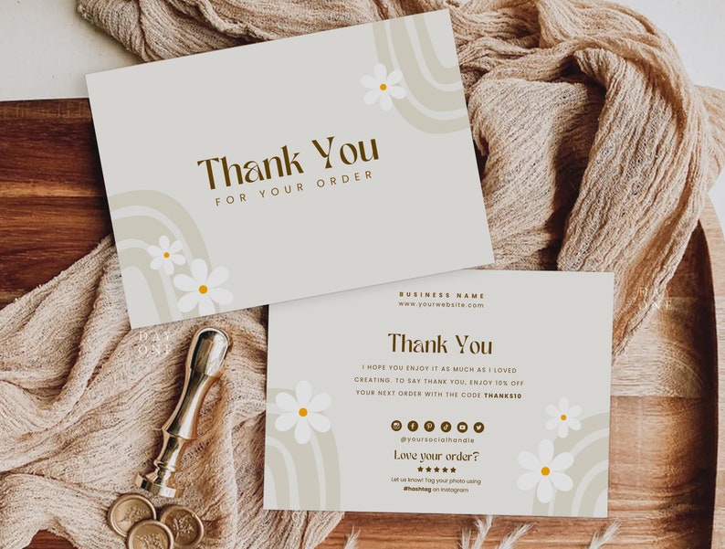 May include: A thank you card with a floral design and the text "Thank You for Your Order". The card is on a wooden surface with a brown fabric.