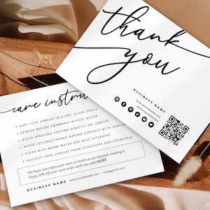 May include: White card with black text that says "Thank you" and "care instructions". The instructions include tips for caring for jewelry, such as keeping it dry and clean, avoiding contact with water and chemicals, and protecting it from scratches. The card also includes a QR code and the business name and website.