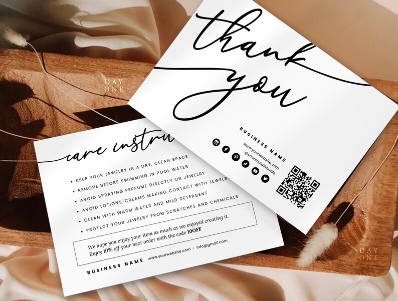 May include: White card with black text that says "Thank you" and "care instructions". The instructions include tips for caring for jewelry, such as keeping it dry and clean, avoiding contact with water and chemicals, and protecting it from scratches. The card also includes a QR code and the business name and website.