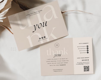 May include: A thank you card with a beige background and black text. The card says "Thank you" in a stylized font. The back of the card has a logo, contact information, and a QR code.