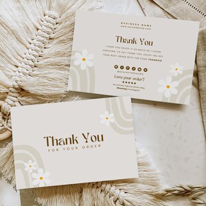 May include: A thank you card with a brown and white abstract design featuring a rainbow and white daisies. The card says "Thank You" and "Thank You for your order".
