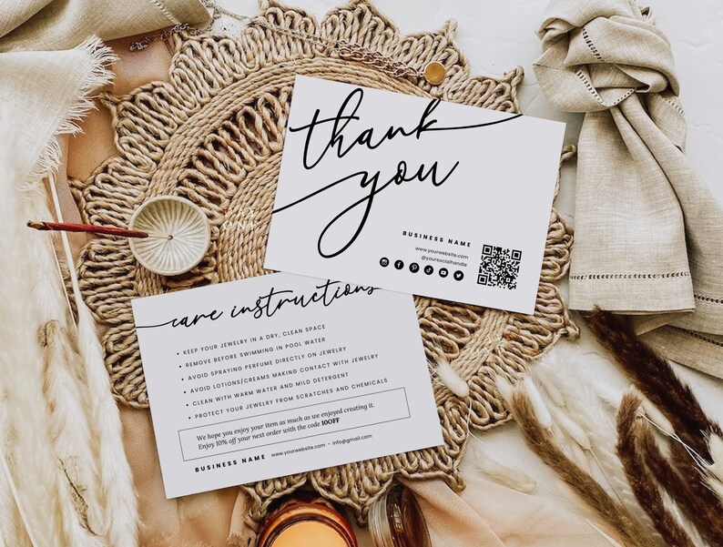 May include: White thank you card with black calligraphy text, care instructions, and business name. The card includes a QR code and social media icons. The card is on a woven straw mat.