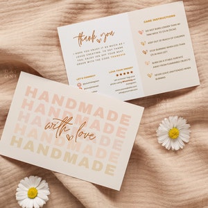 May include: A card with the text "Handmade with love" repeated in a gradient of pink and orange colors. The card also includes care instructions for a candle, such as trimming the wick to 1/4 inch and keeping it out of reach of children.