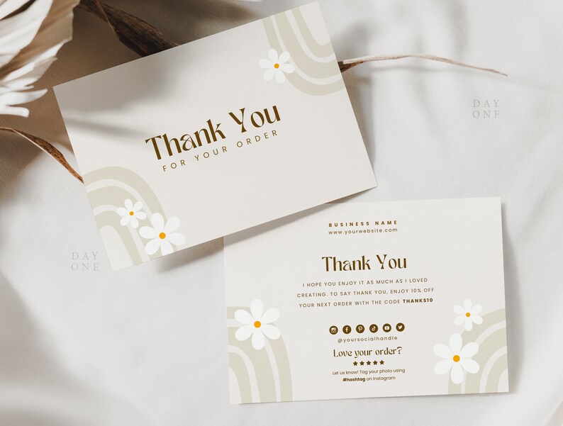 May include: Thank you card with a brown and beige abstract design featuring white daisies. The card says "Thank You for your order" and includes the text "Day One".