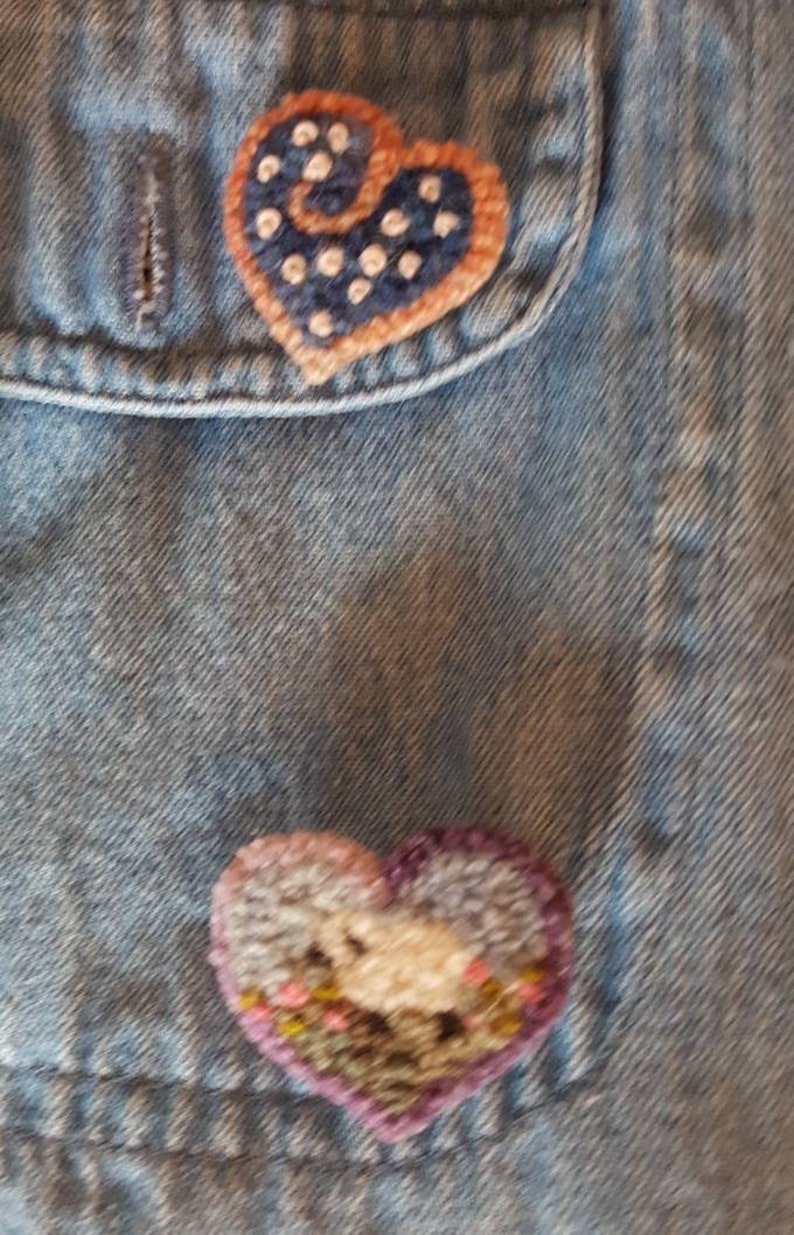 11 Vintage Handmade Felting and Rug Hooked Pins on Denim Shirt.