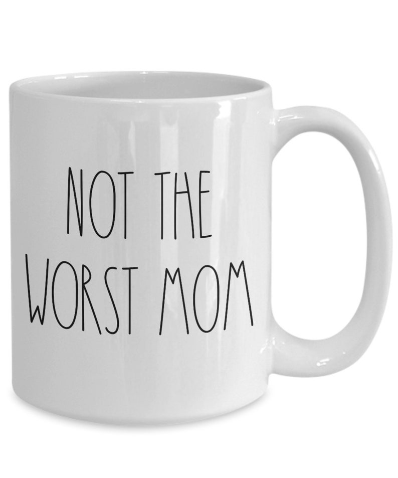 May include: White ceramic coffee mug with black text that reads "Not the worst mom".