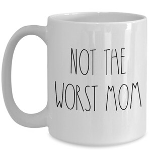 May include: White ceramic coffee mug with black text that reads "Not the worst mom".